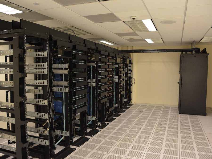 Colocation hall — rows of customer racks at a landing station campus
