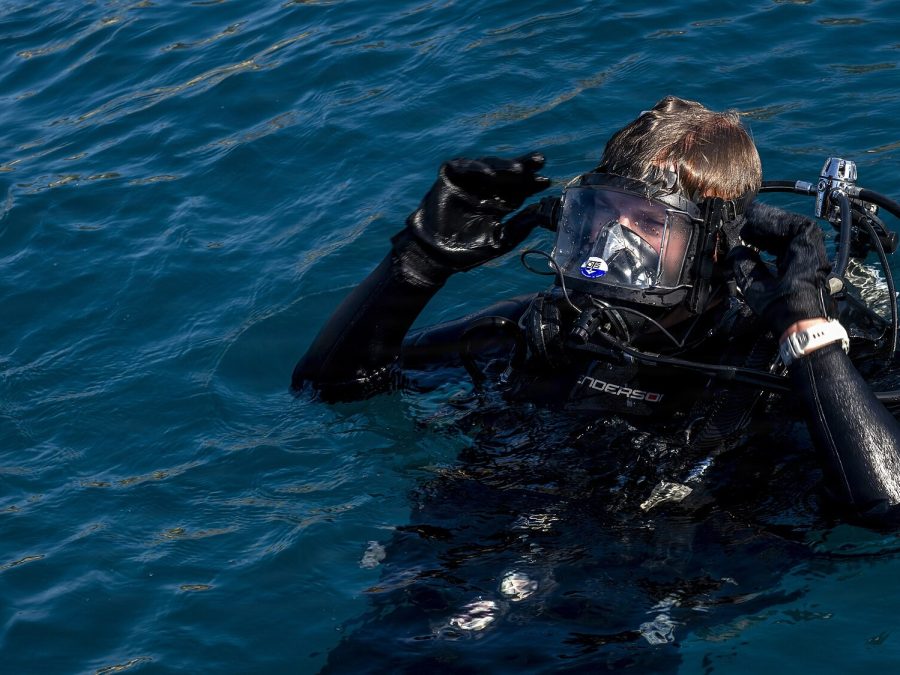 Diver-assisted shore-end cable pull-in at a landing beach
